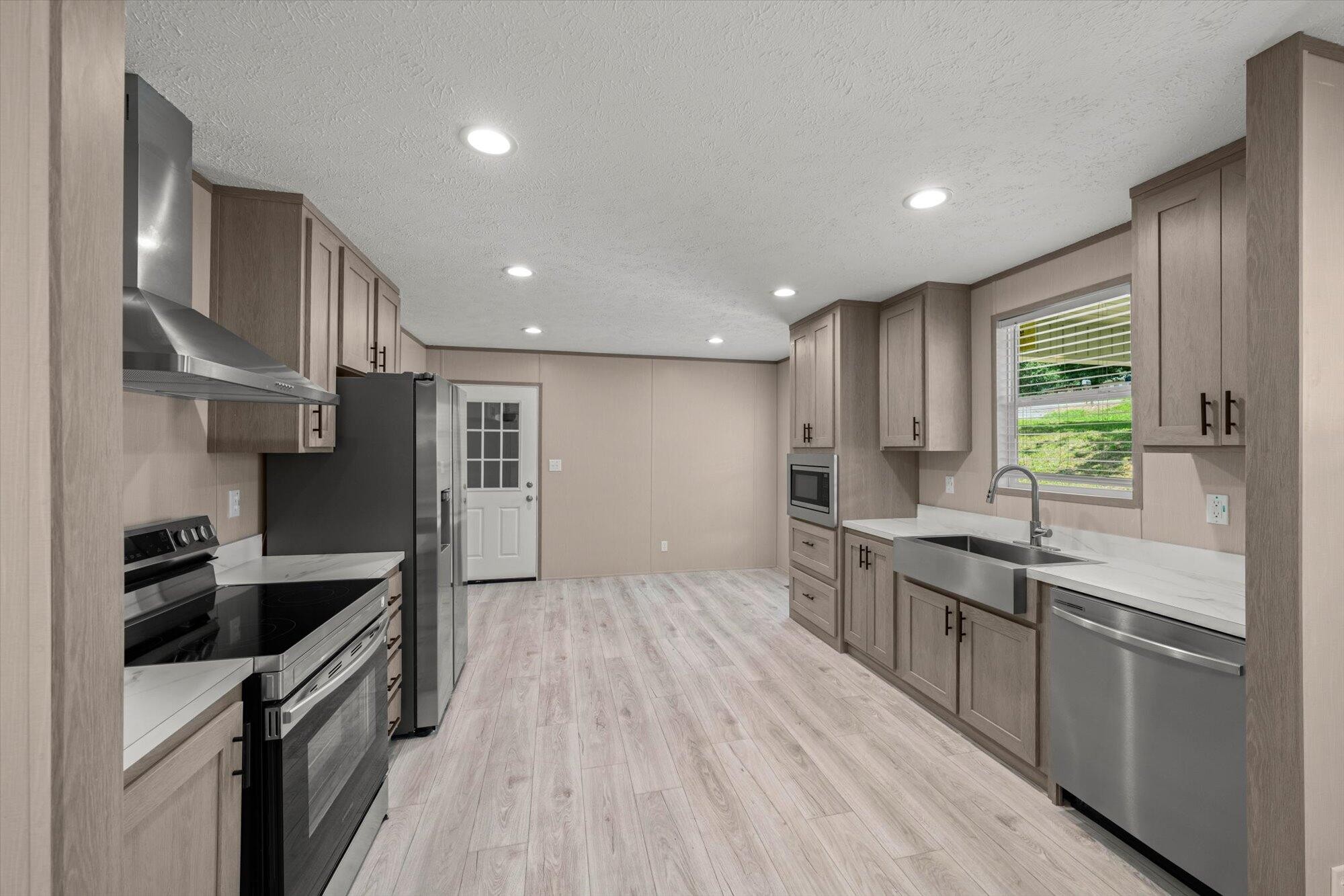 612 Caldwell Road Loudon, TN 37774 - Photo 5 of 16 a kitchen with stainless steel appliances granite countertop a sink a stove and a refrigerator