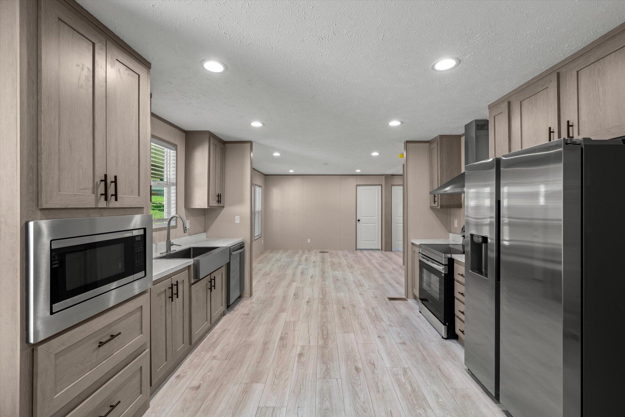 612 Caldwell Road Loudon, TN 37774 - Photo 6 of 16 a kitchen with stainless steel appliances granite countertop a refrigerator a stove and a wooden floors