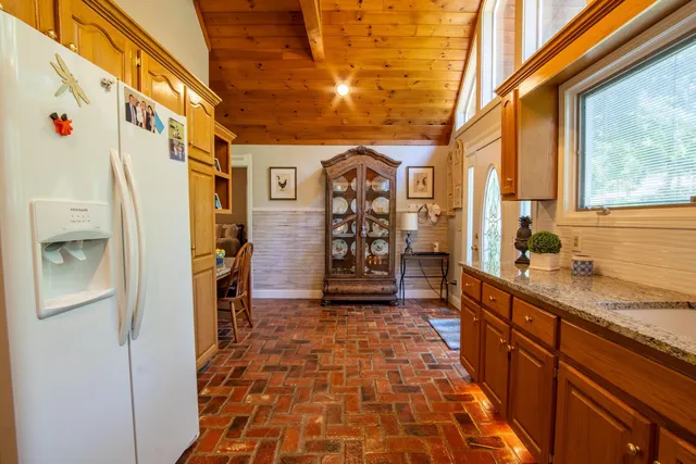 a hallway with a large window and a refrigerator