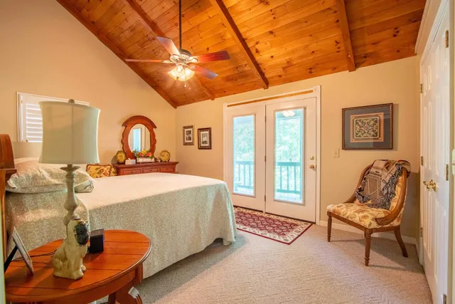 a bedroom with a bed and glass windows