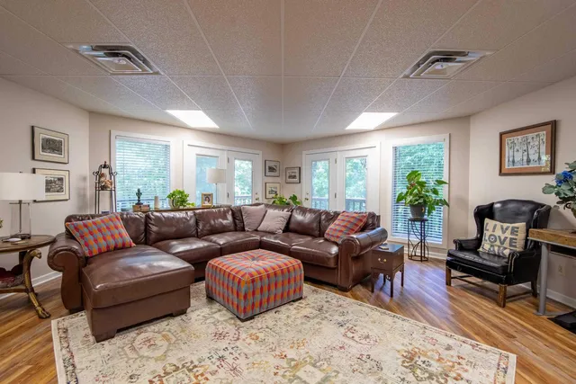 a living room with furniture a rug and a window