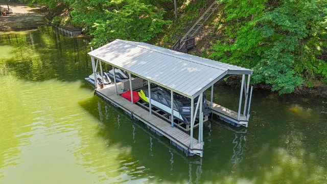 a aerial view of a house with swimming pool next to a yard