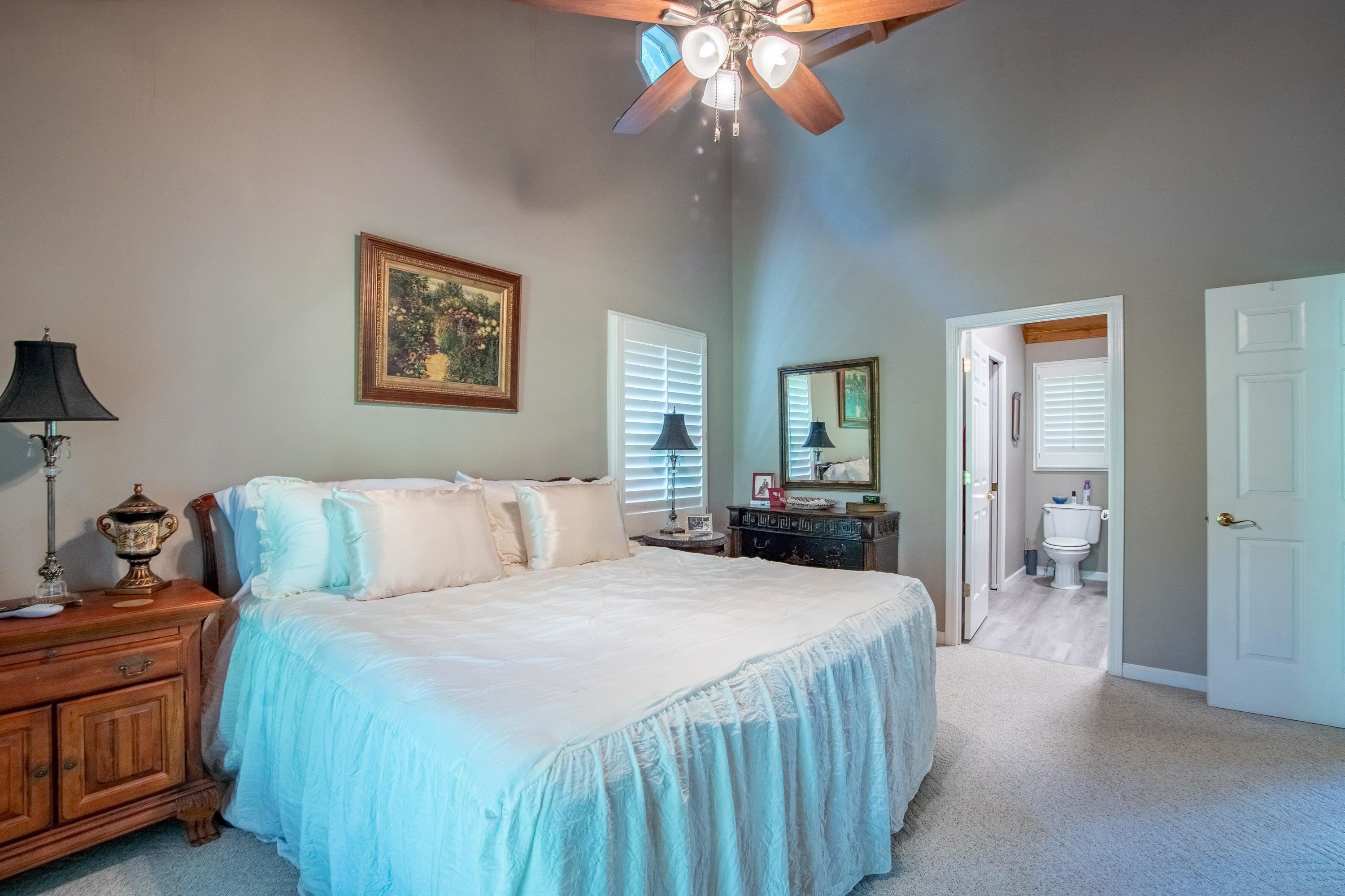 140 Ridge View Savannah, TN 38372 - Photo 32 of 36 a bedroom with a bed and a chandelier