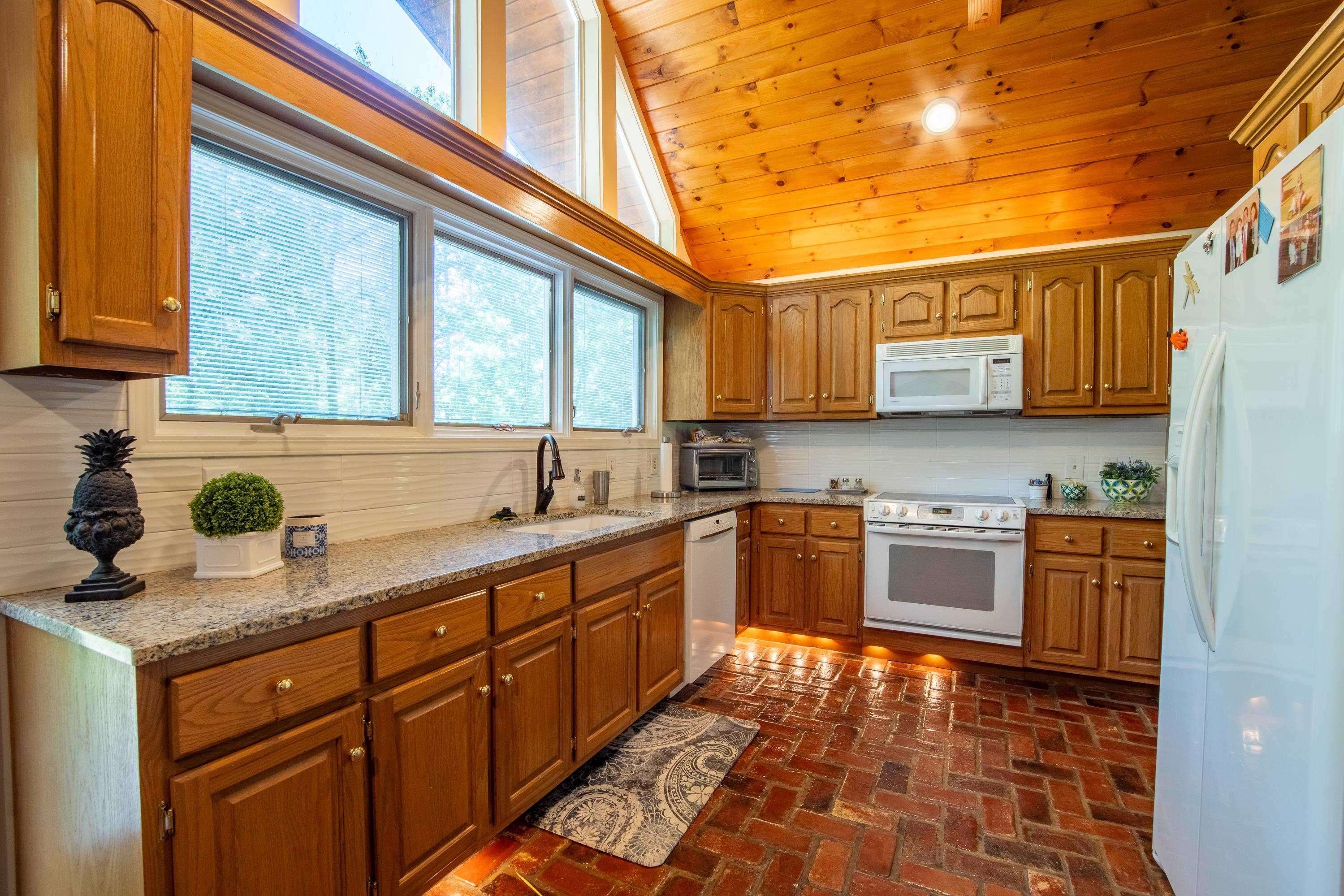 140 Ridge View Savannah, TN 38372 - Photo 10 of 36 a kitchen with stainless steel appliances granite countertop a sink and cabinets