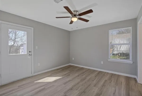 wooden floor in an empty room with a window