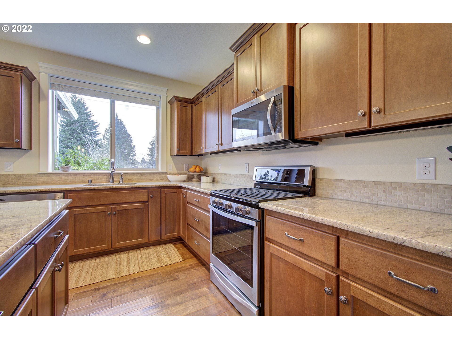 101 North 38th Place Ridgefield, WA 98642 - Photo 11 of 32 a kitchen with stainless steel appliances granite countertop a stove a sink and a microwave