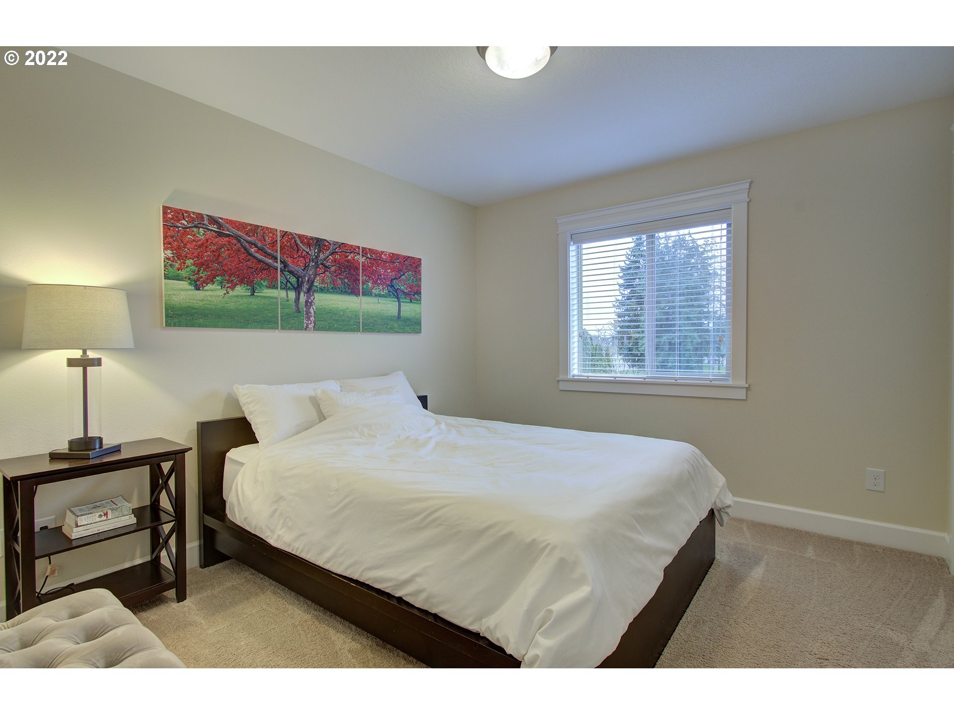 101 North 38th Place Ridgefield, WA 98642 - Photo 13 of 32 a bedroom with a bed a wall painting and a lamp
