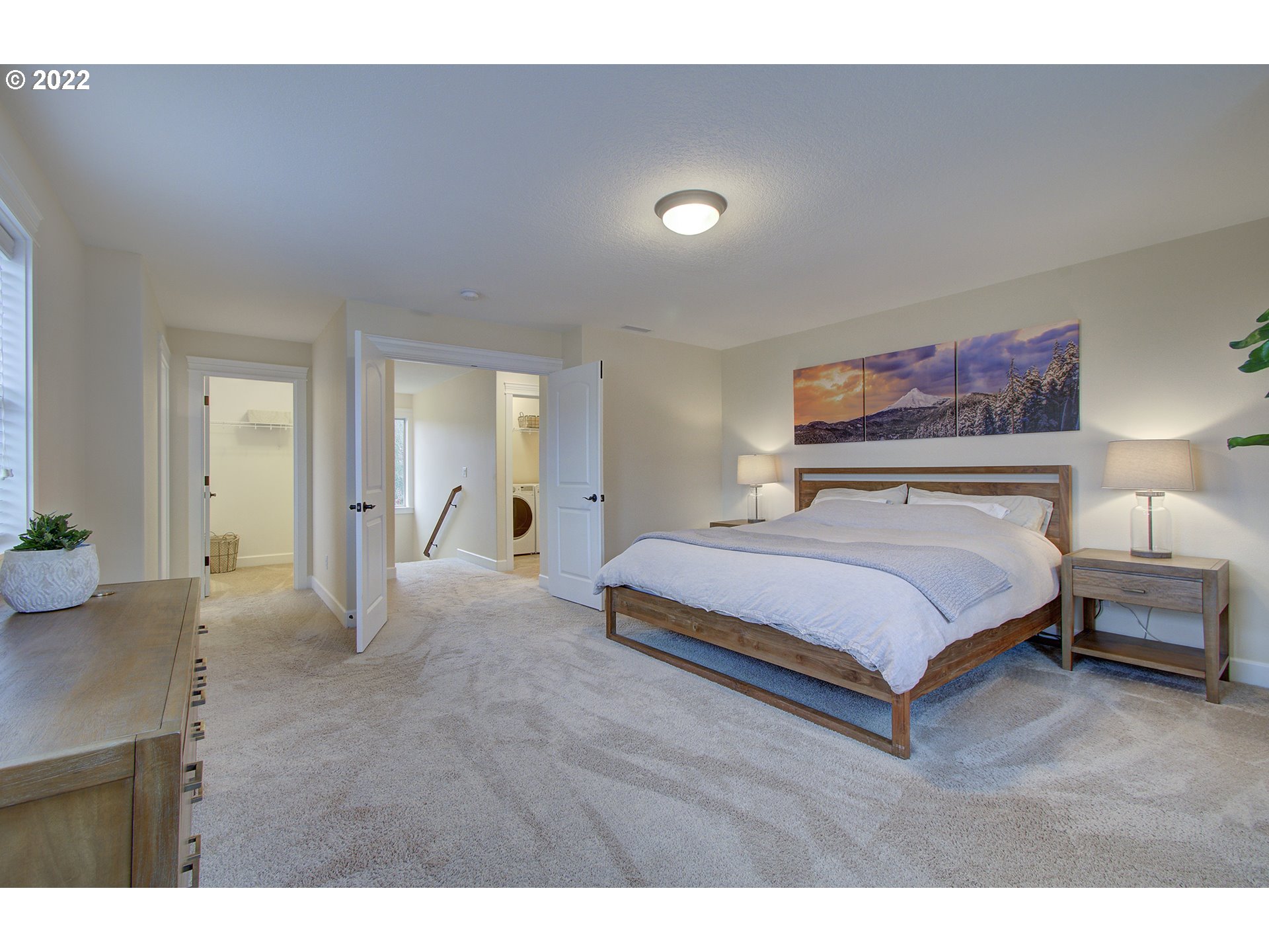 101 North 38th Place Ridgefield, WA 98642 - Photo 23 of 32 a bedroom with a large bed and paintings on the wall