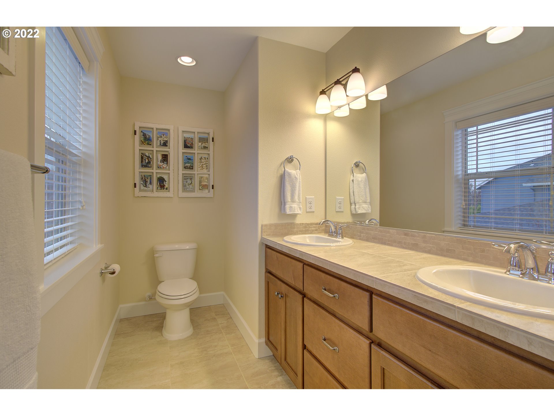 101 North 38th Place Ridgefield, WA 98642 - Photo 25 of 32 a bathroom with a sink a toilet and a mirror