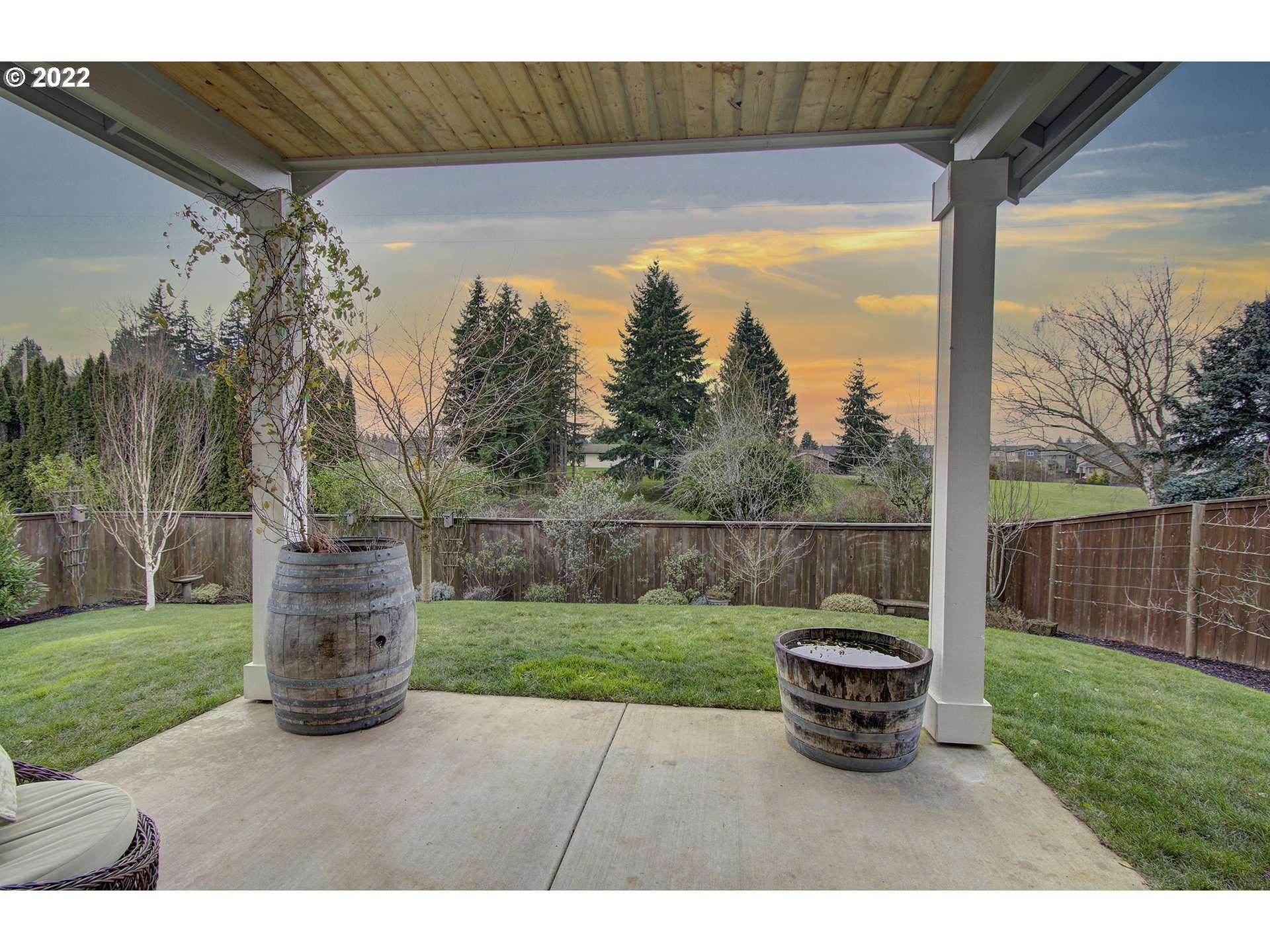 101 North 38th Place Ridgefield, WA 98642 - Photo 29 of 32 a view of a yard with large trees and a wooden fence