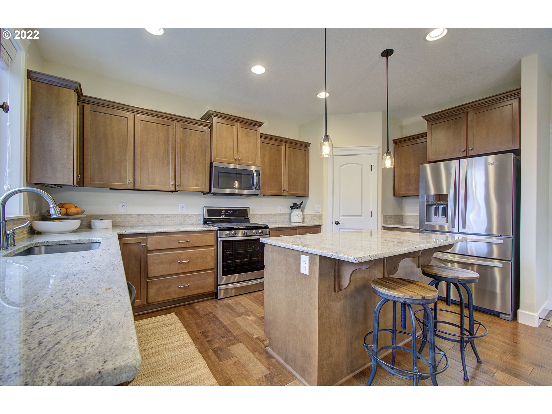 101 North 38th Place Ridgefield, WA 98642 - Photo 10 of 32 a kitchen with kitchen island a refrigerator stove and microwave