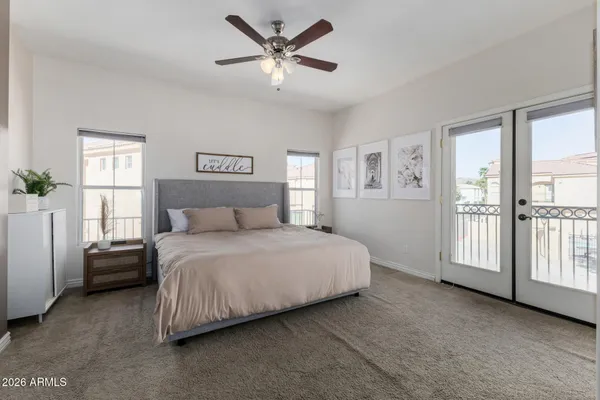 a spacious bedroom with a bed and a window