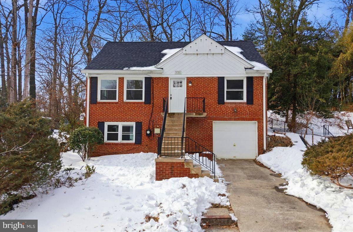 a front view of a house with a yard covered in snow