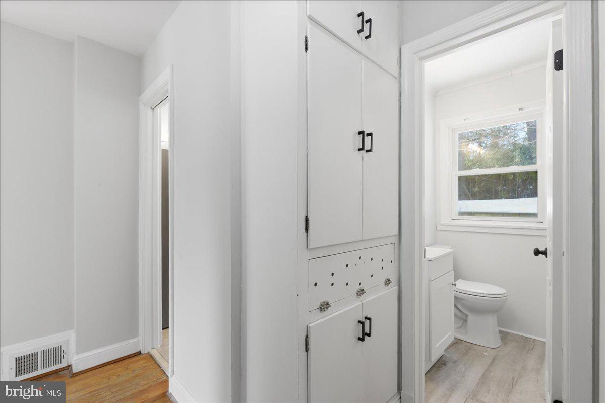 9704 Lorain Avenue Silver Spring, MD 20901 - Photo 11 of 26 a bathroom with a granite countertop sink a toilet and shower