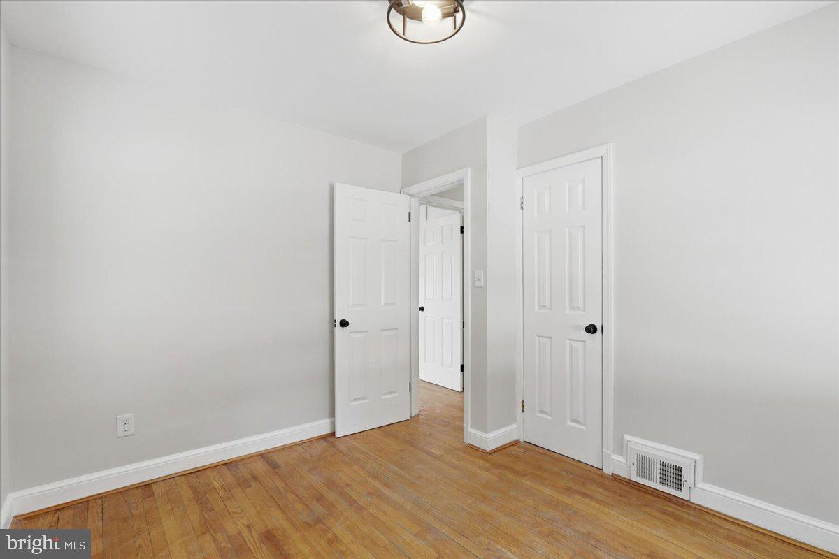 9704 Lorain Avenue Silver Spring, MD 20901 - Photo 15 of 26 a view of an empty room with wooden floor