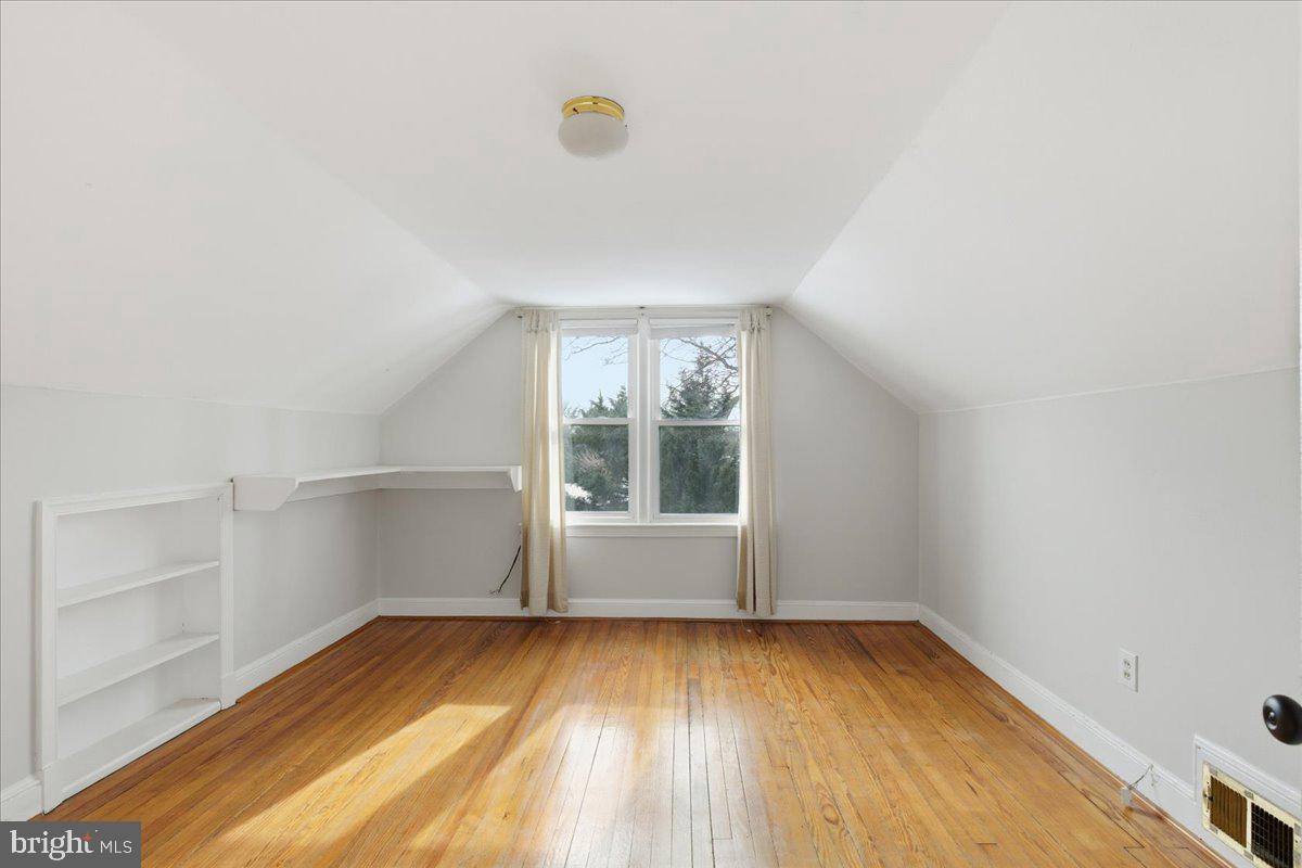 9704 Lorain Avenue Silver Spring, MD 20901 - Photo 18 of 26 a view of empty room with wooden floor and fan