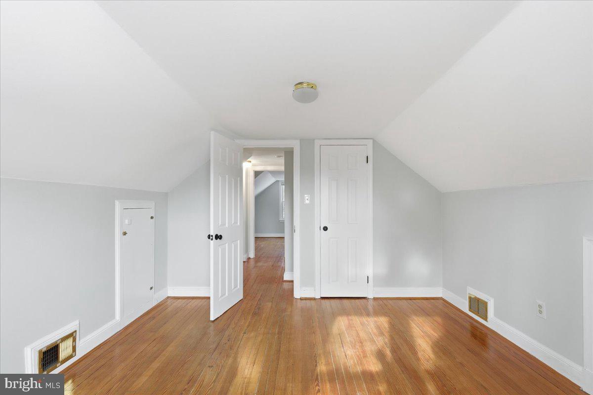 9704 Lorain Avenue Silver Spring, MD 20901 - Photo 19 of 26 a view of an empty room and wooden floor