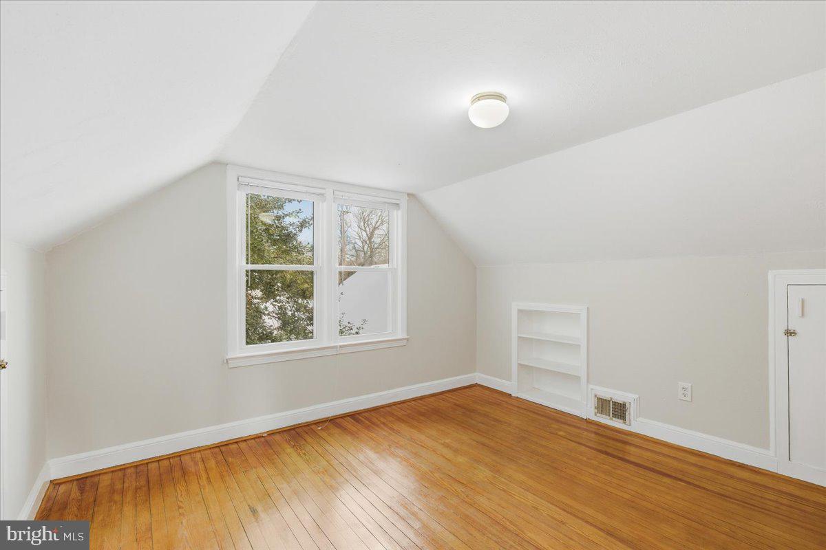 9704 Lorain Avenue Silver Spring, MD 20901 - Photo 22 of 26 an empty room with wooden floor and windows