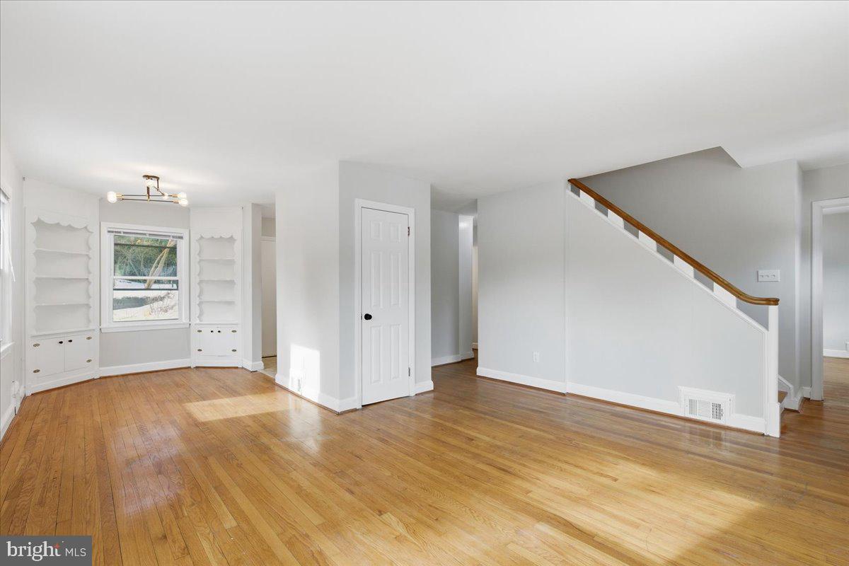 9704 Lorain Avenue Silver Spring, MD 20901 - Photo 3 of 26 a view of a room with wooden floor and windows