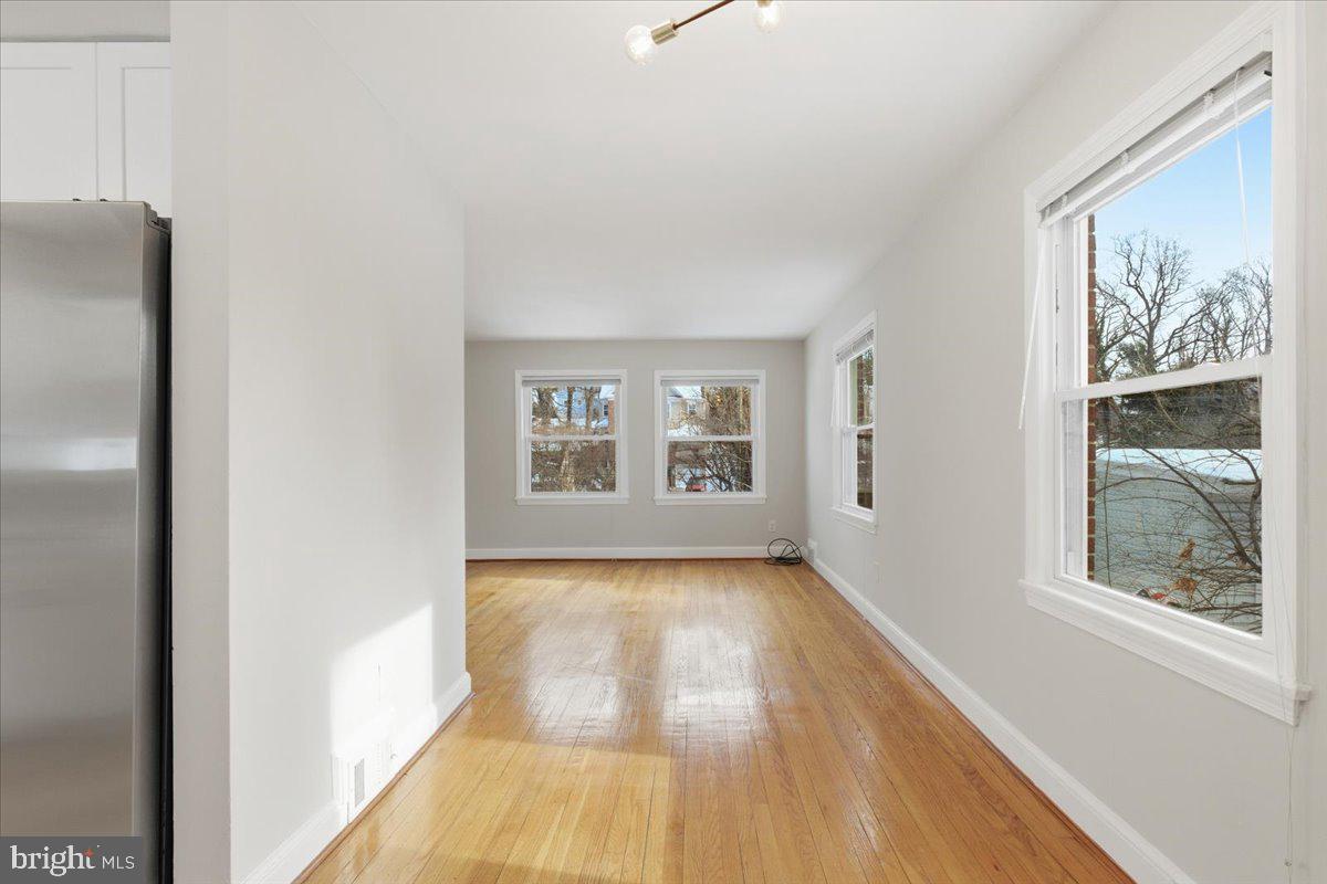 9704 Lorain Avenue Silver Spring, MD 20901 - Photo 6 of 26 a view of an empty room with a window and wooden floor
