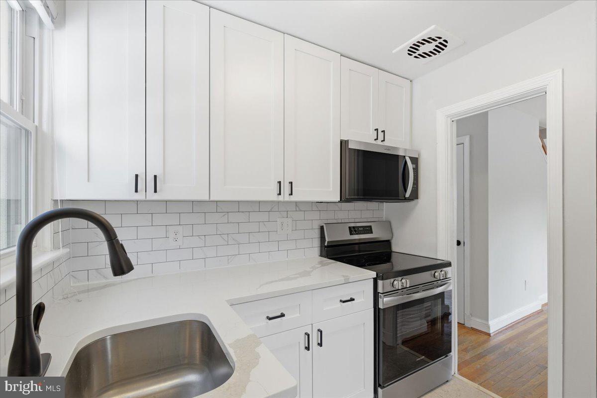 9704 Lorain Avenue Silver Spring, MD 20901 - Photo 8 of 26 a kitchen with a appliances and cabinets
