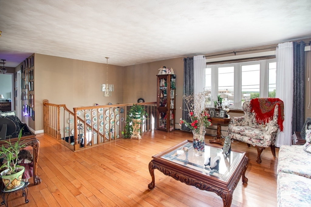 166 Stonehaven Road Fall River, MA 02723 - Photo 3 of 33 a living room with furniture a rug and a floor to ceiling window