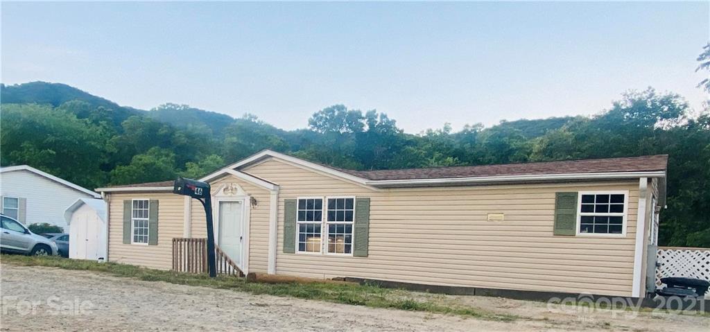46 Austin Road Clyde, NC 28721 - Photo 2 of 20 a view of a white house next to a yard