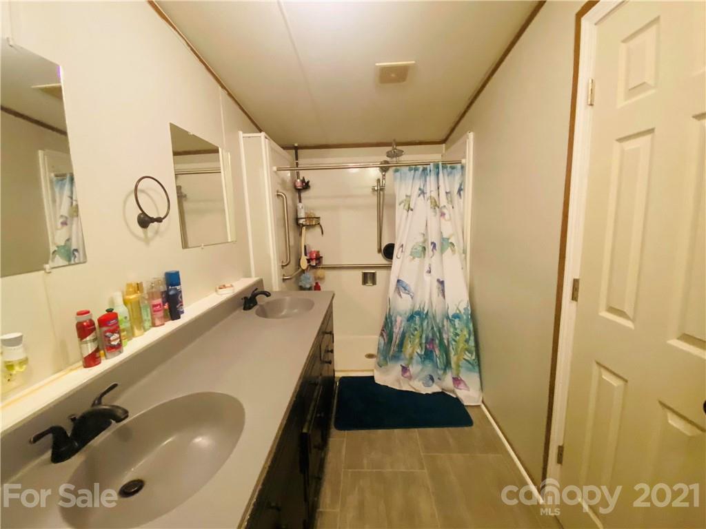 46 Austin Road Clyde, NC 28721 - Photo 13 of 20 a bathroom with a tub sink and a shower