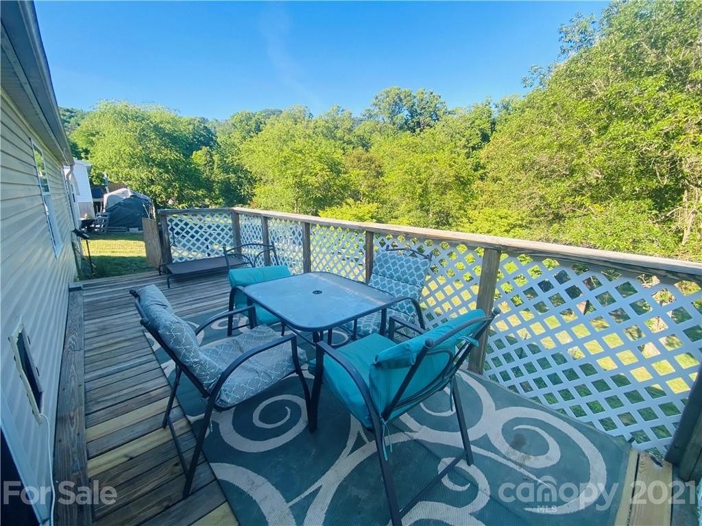 46 Austin Road Clyde, NC 28721 - Photo 4 of 20 a view of a chairs and table on the balcony