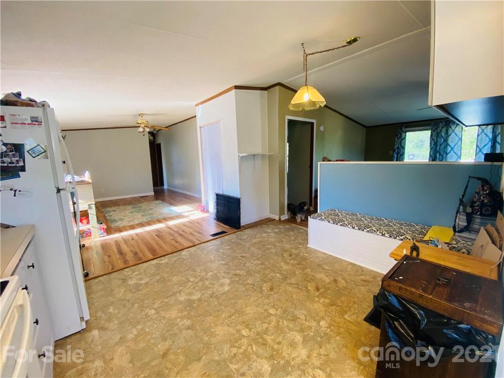 46 Austin Road Clyde, NC 28721 - Photo 8 of 20 a bedroom with a bed and a chandelier