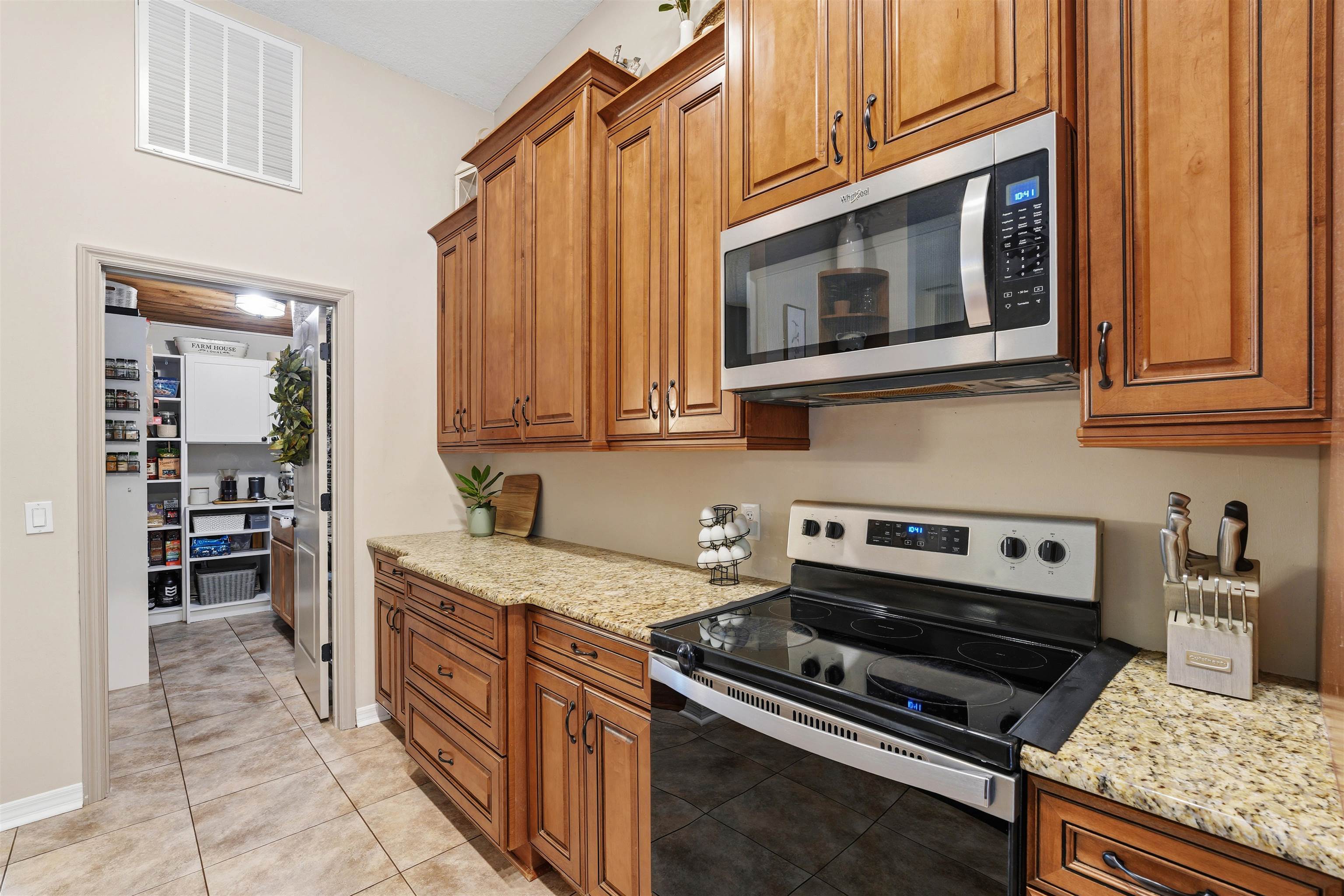 1805 Bennett Road St. Augustine, FL 32092 - Photo 13 of 65 a kitchen with stainless steel appliances granite countertop a stove and a microwave
