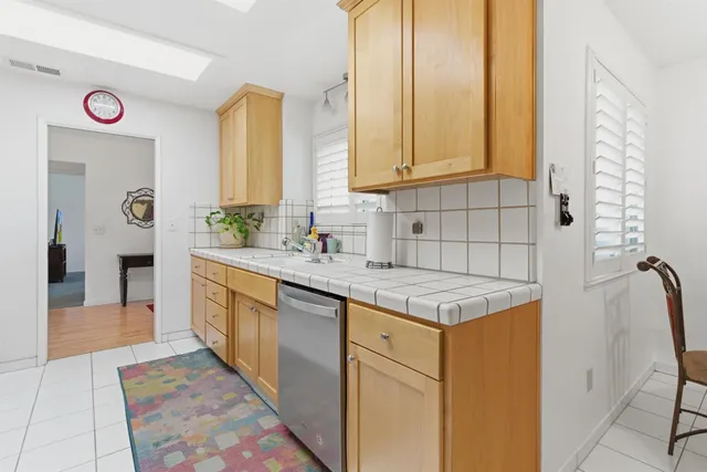 a kitchen with granite countertop a sink and a stove top oven