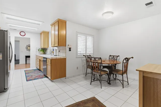 a view of a dining room with furniture and window