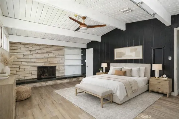 a large bedroom with a bed and a fireplace