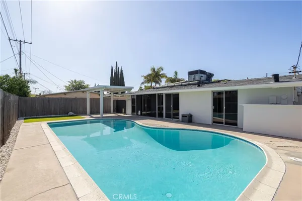 a view of a backyard with wooden fence
