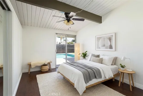 a bedroom with a large bed and a chandelier
