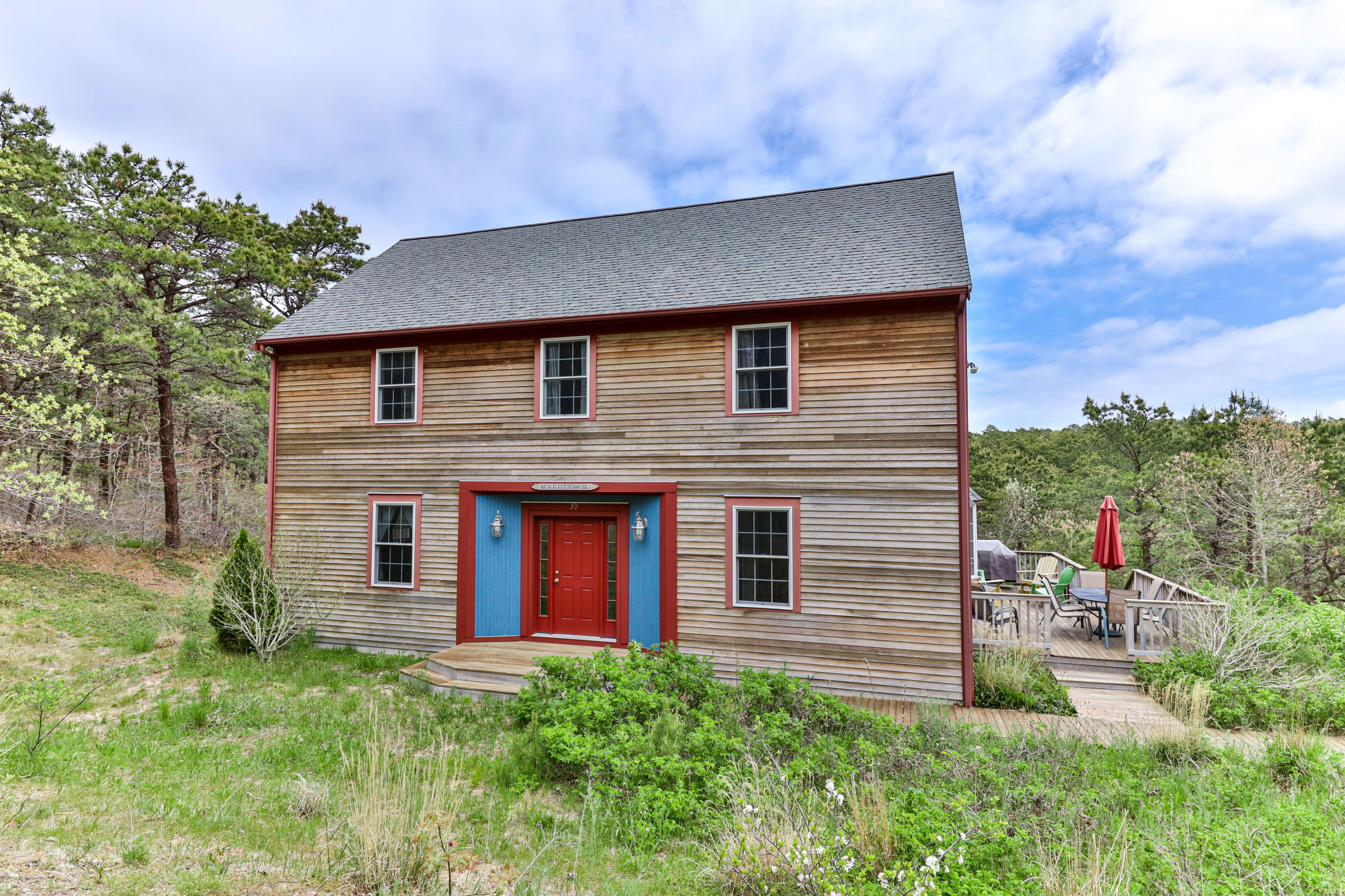 39 South Highland Road Truro, MA 02666 - Photo 1 of 46 a backyard of a house with plants and outdoor seating