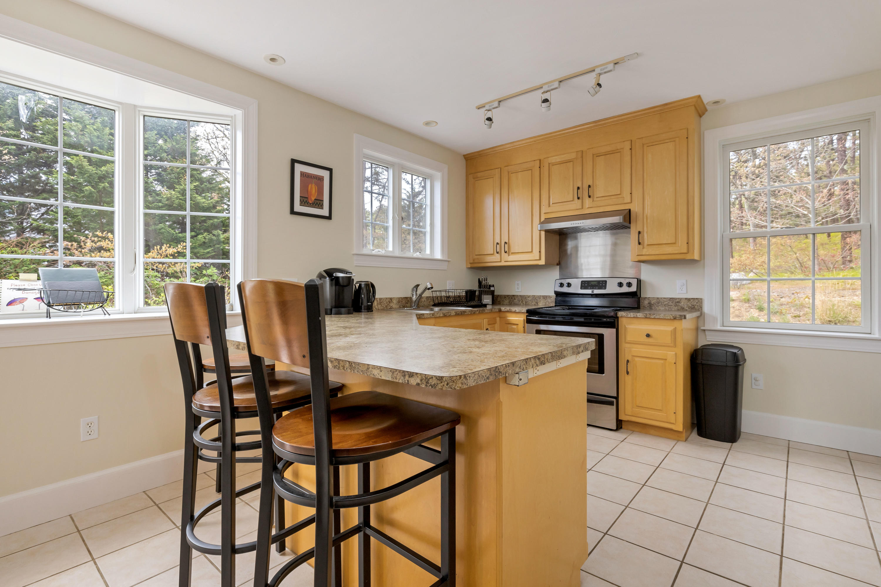 39 South Highland Road Truro, MA 02666 - Photo 11 of 46 a kitchen with granite countertop a stove a sink a dining table and chairs