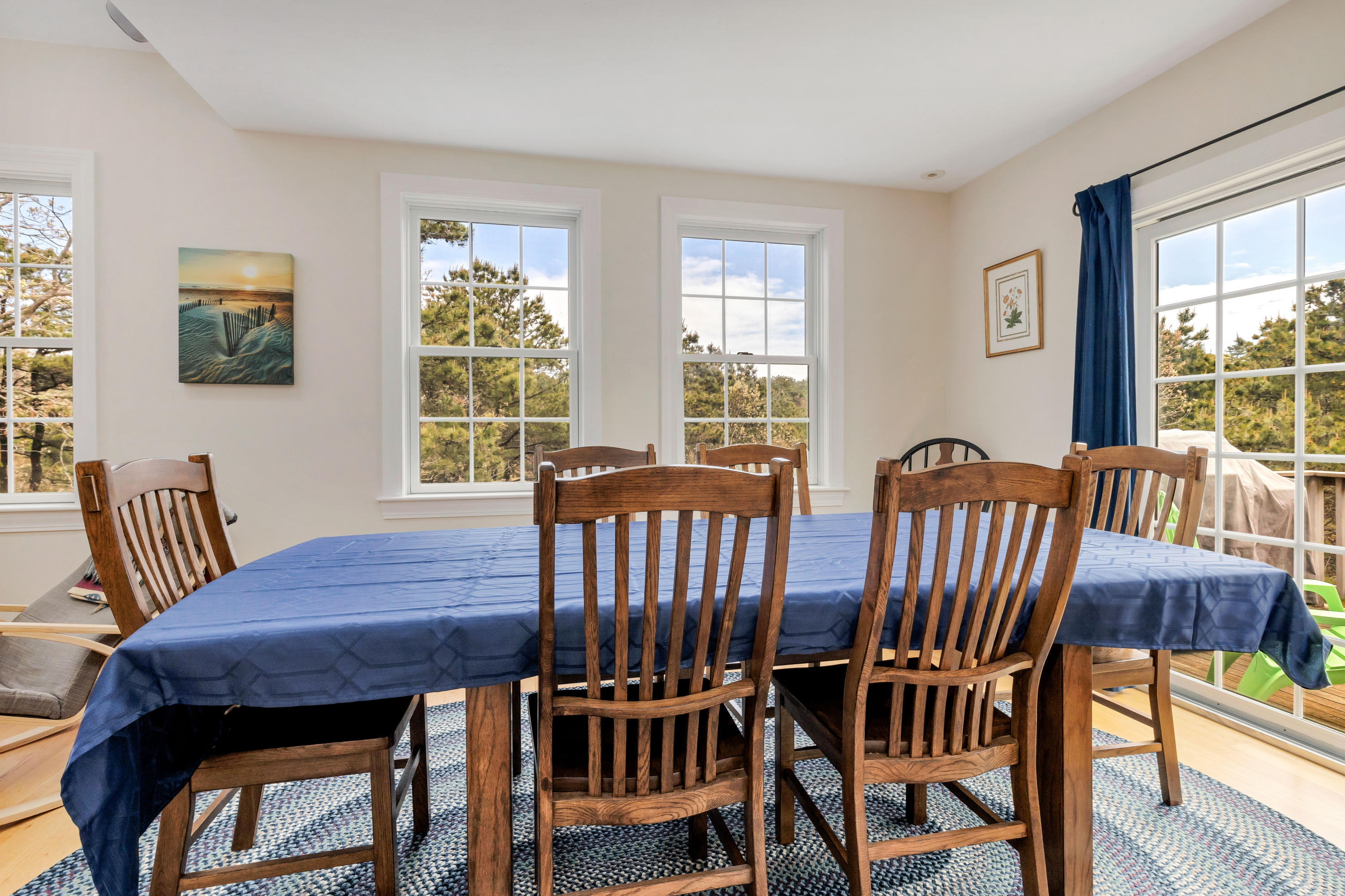 39 South Highland Road Truro, MA 02666 - Photo 14 of 46 a view of a dining room with furniture a couch and wooden floor