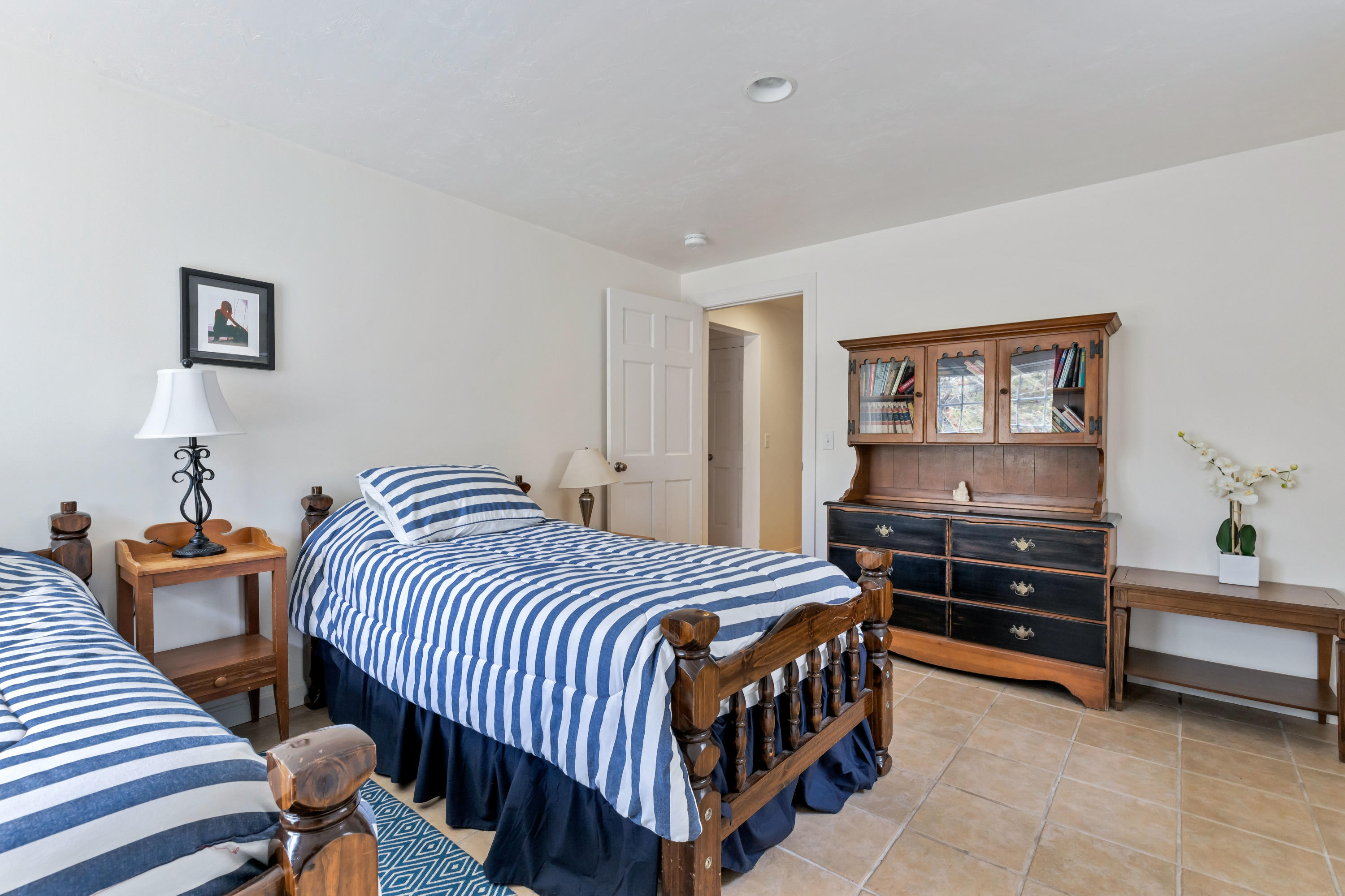 39 South Highland Road Truro, MA 02666 - Photo 42 of 46 a bedroom with a bed and a chandelier