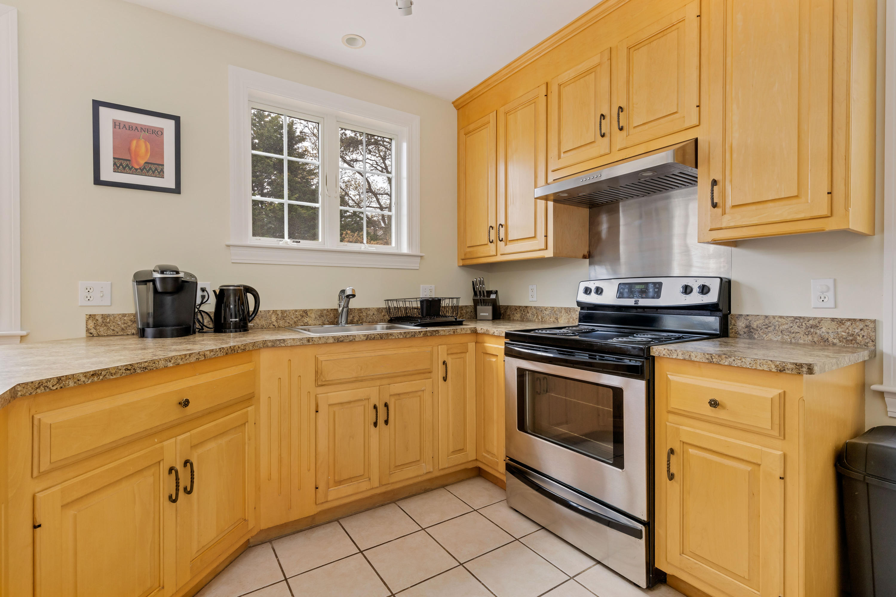 39 South Highland Road Truro, MA 02666 - Photo 10 of 46 a kitchen with stainless steel appliances granite countertop a stove a sink and a white cabinets