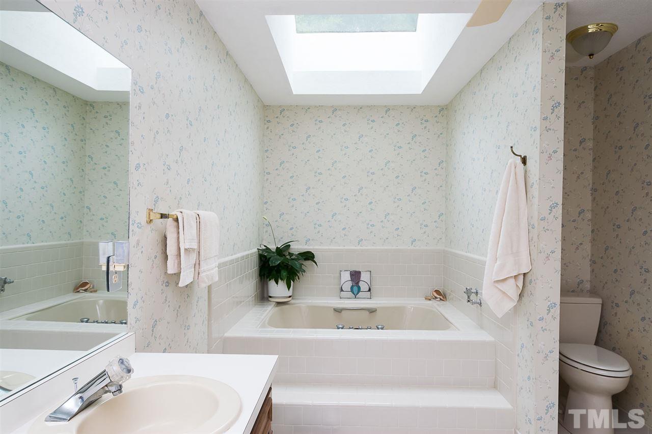3020 Daventry Lane Raleigh, NC 27613 - Photo 14 of 25 a bathroom with a tub toilet sink and mirror