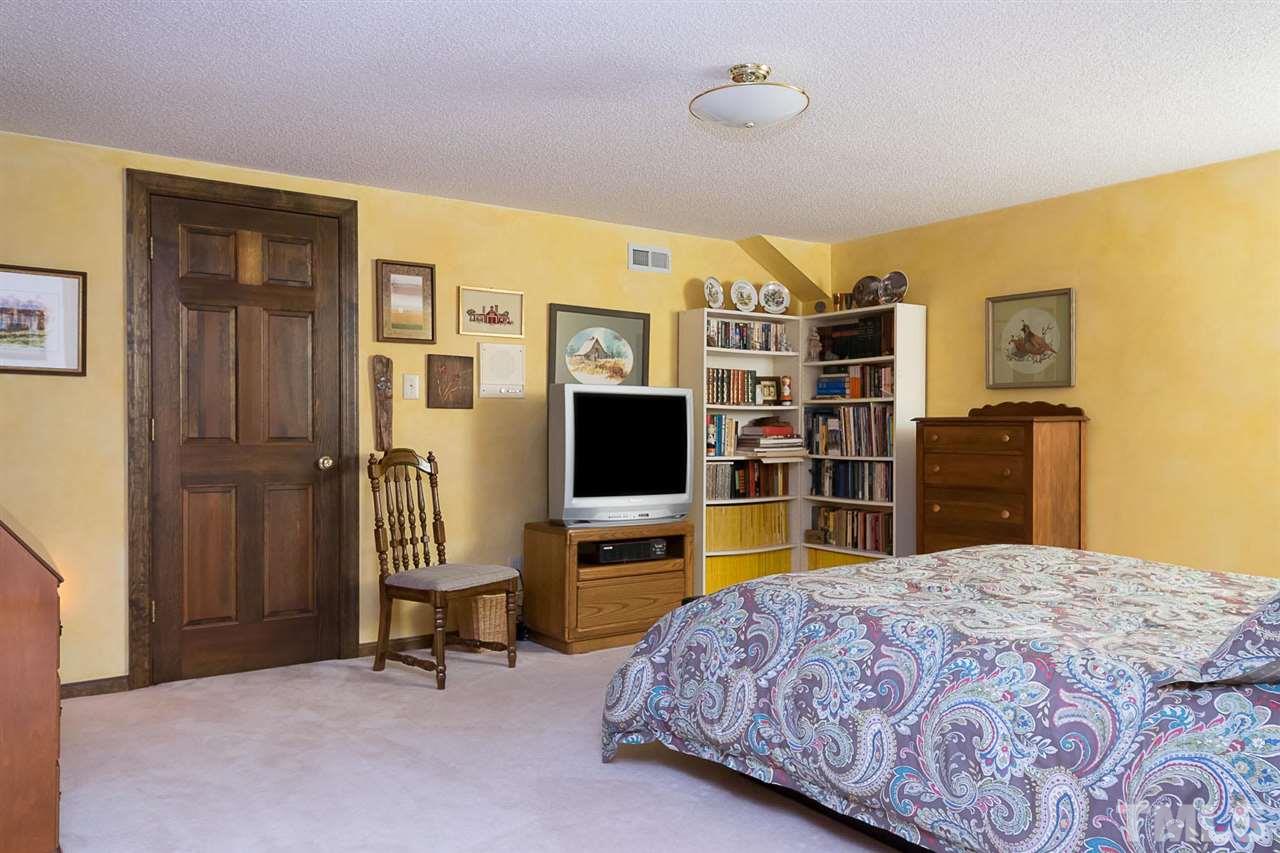 3020 Daventry Lane Raleigh, NC 27613 - Photo 18 of 25 a bedroom with a bed and a flat screen tv
