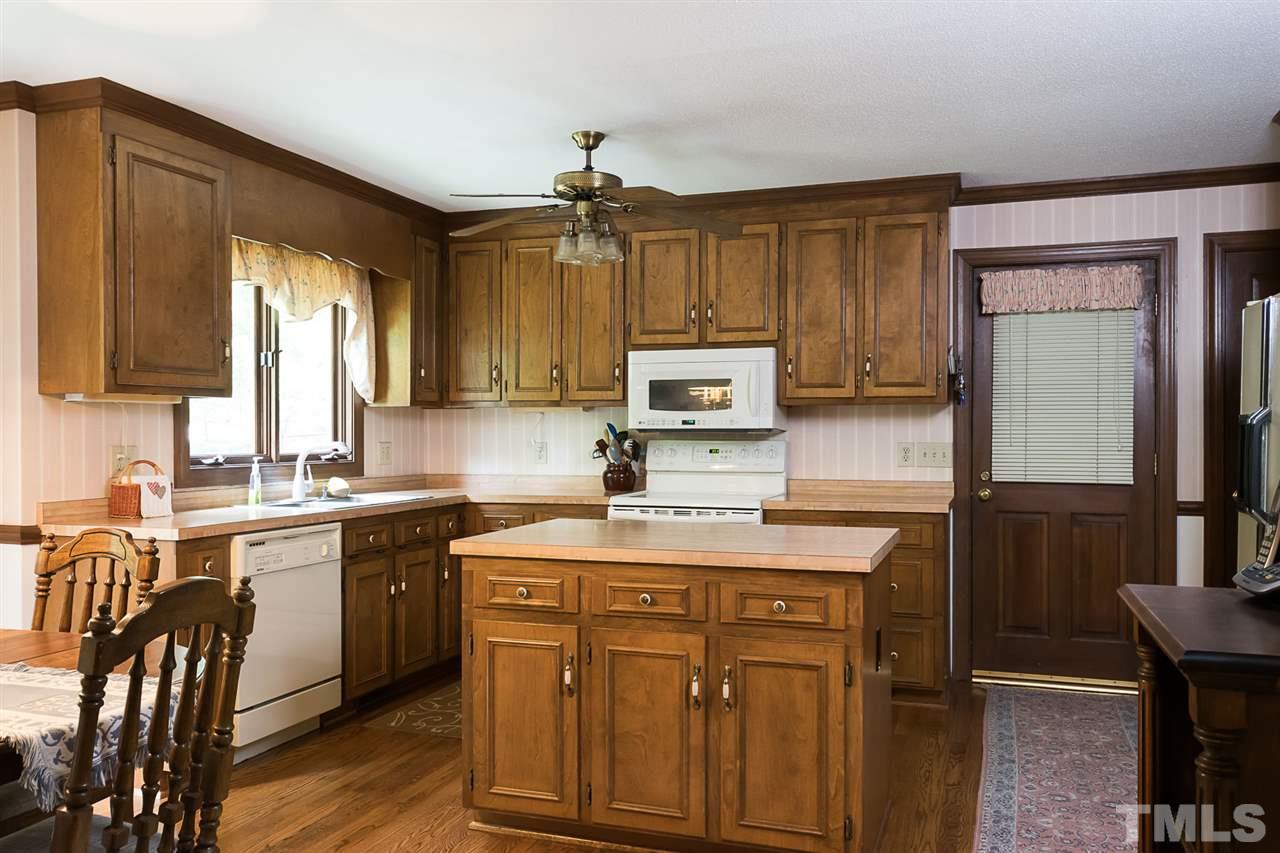 3020 Daventry Lane Raleigh, NC 27613 - Photo 7 of 25 a kitchen with kitchen island granite countertop a sink appliances cabinets and furniture