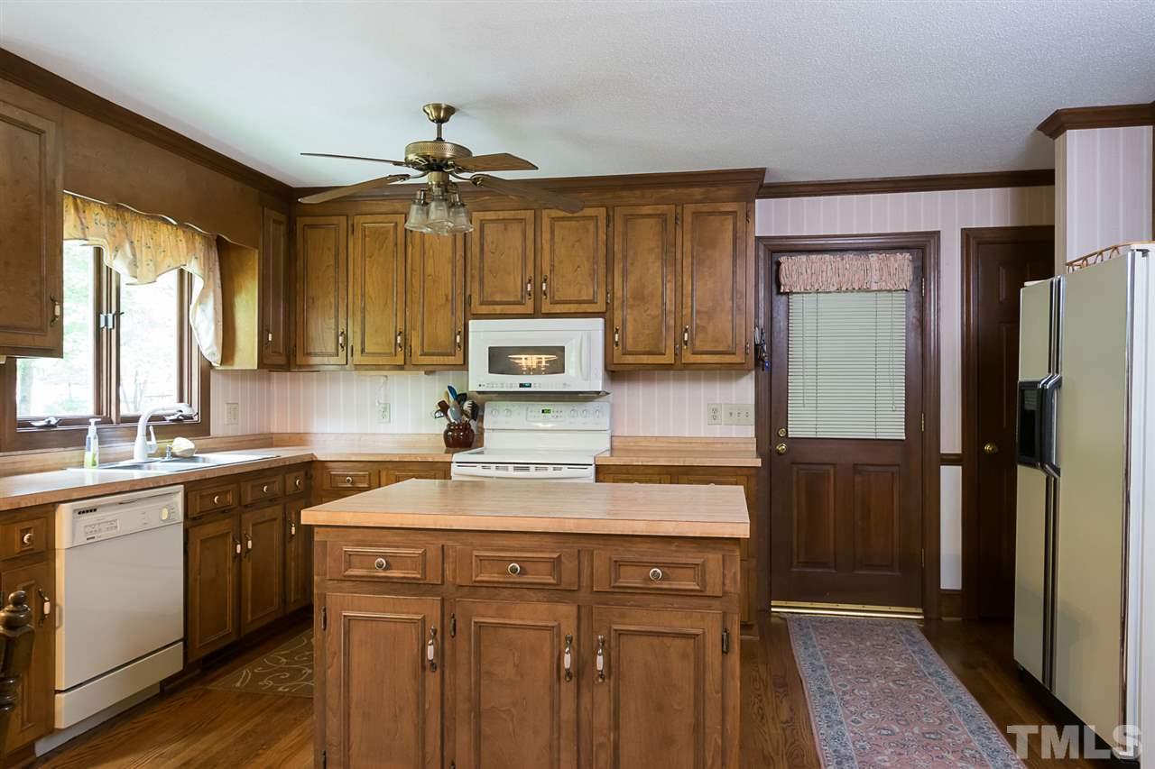 3020 Daventry Lane Raleigh, NC 27613 - Photo 8 of 25 a kitchen with stainless steel appliances a sink cabinets and a refrigerator