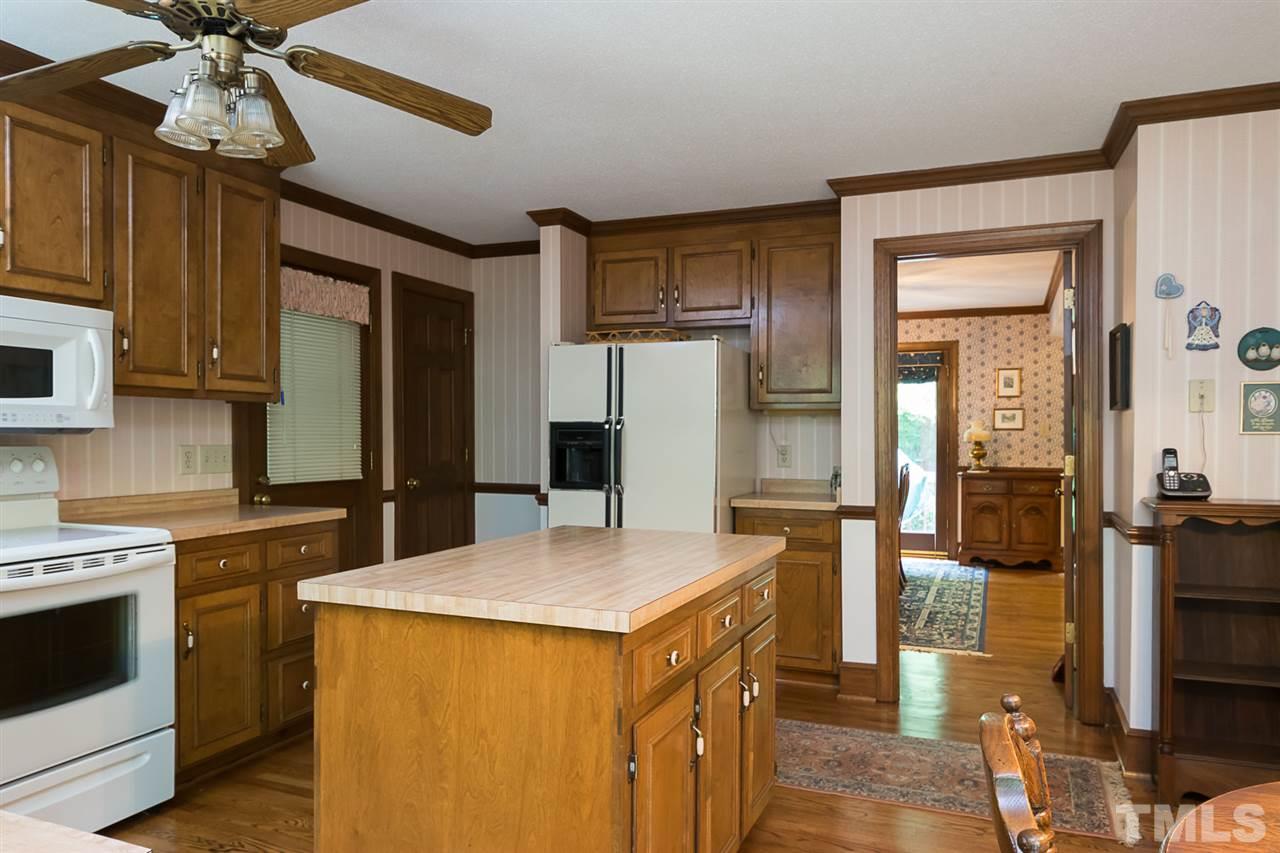 3020 Daventry Lane Raleigh, NC 27613 - Photo 9 of 25 a kitchen with a stove a refrigerator and a sink