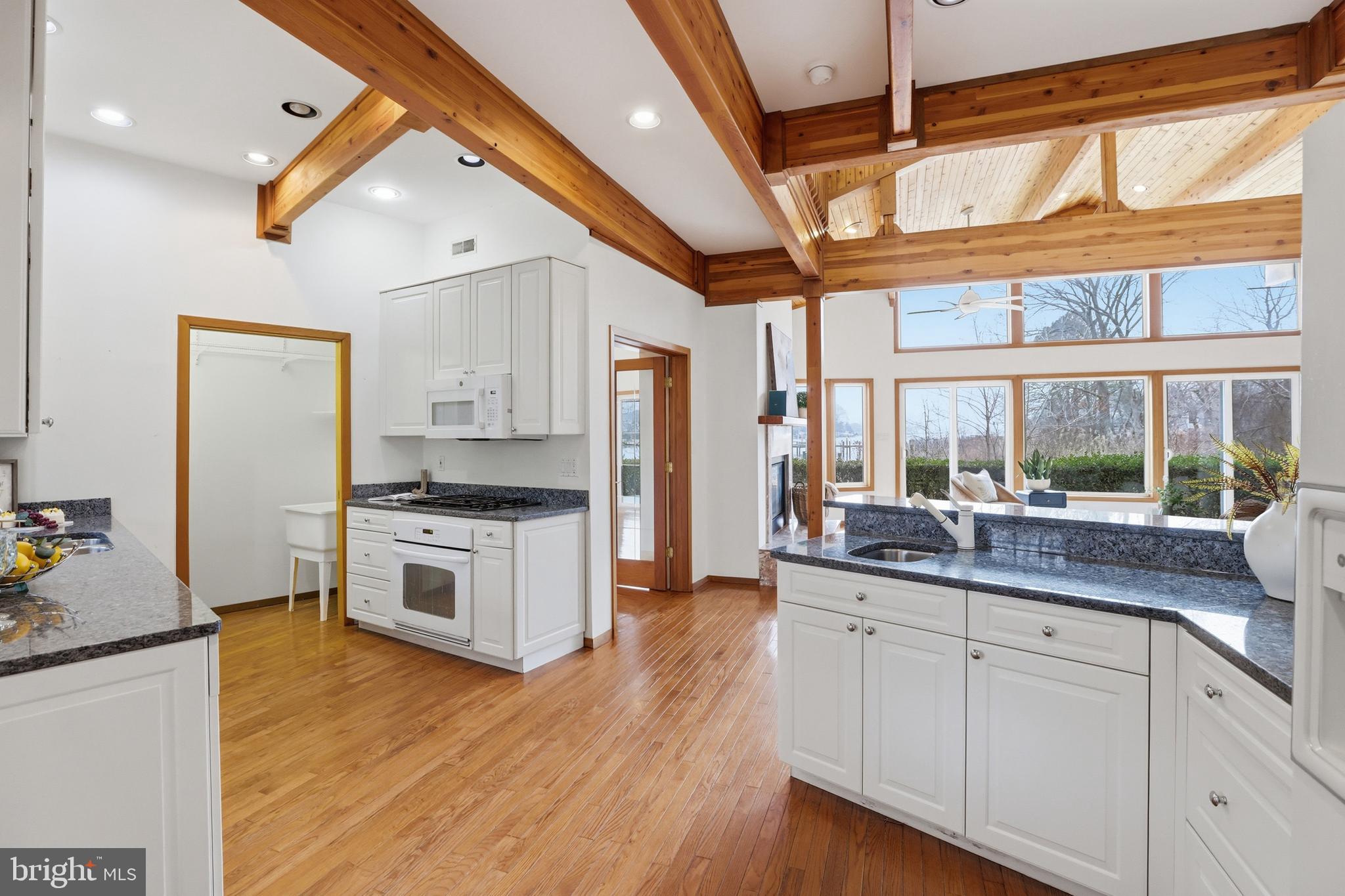 5931 Tyler Road Deale, MD 20751 - Photo 17 of 77 a kitchen with granite countertop white cabinets and stainless steel appliances