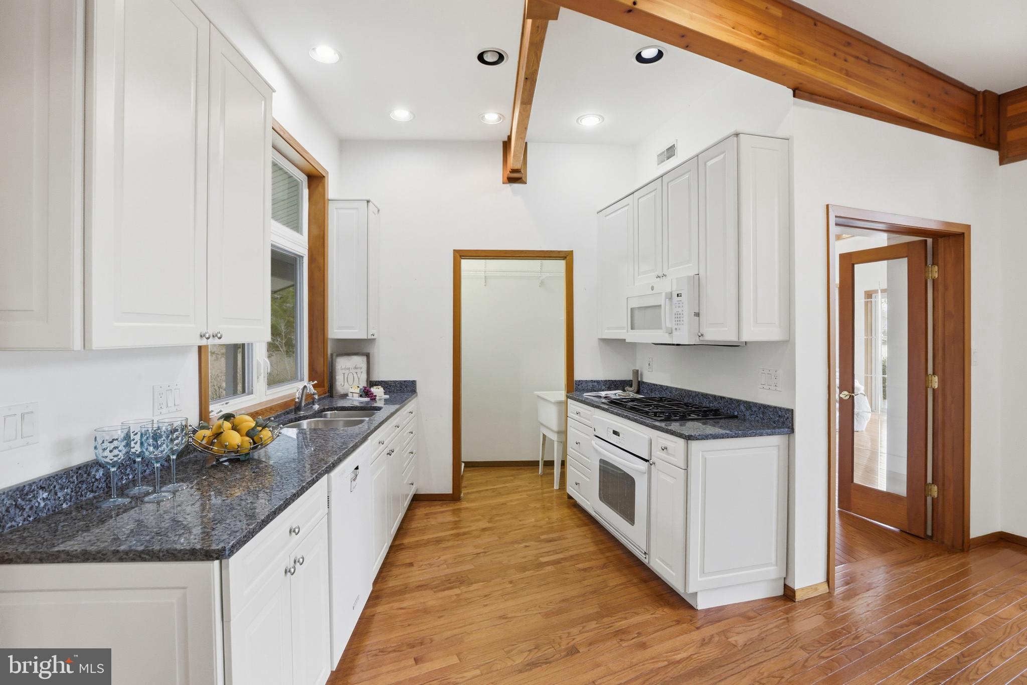 5931 Tyler Road Deale, MD 20751 - Photo 19 of 77 a kitchen with stainless steel appliances granite countertop a stove a sink and a refrigerator