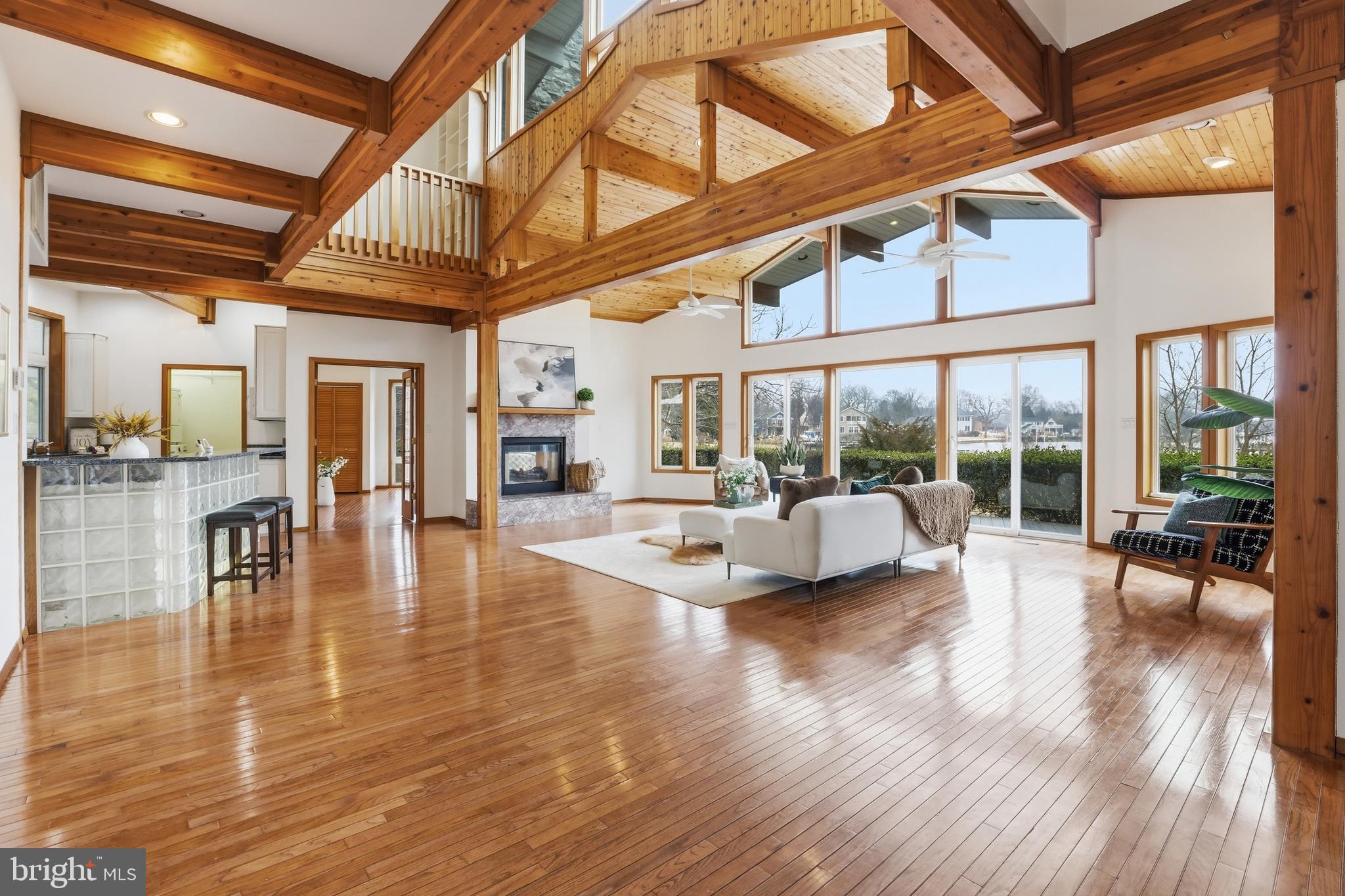 5931 Tyler Road Deale, MD 20751 - Photo 2 of 77 a view of an empty room with wooden floor and a large window