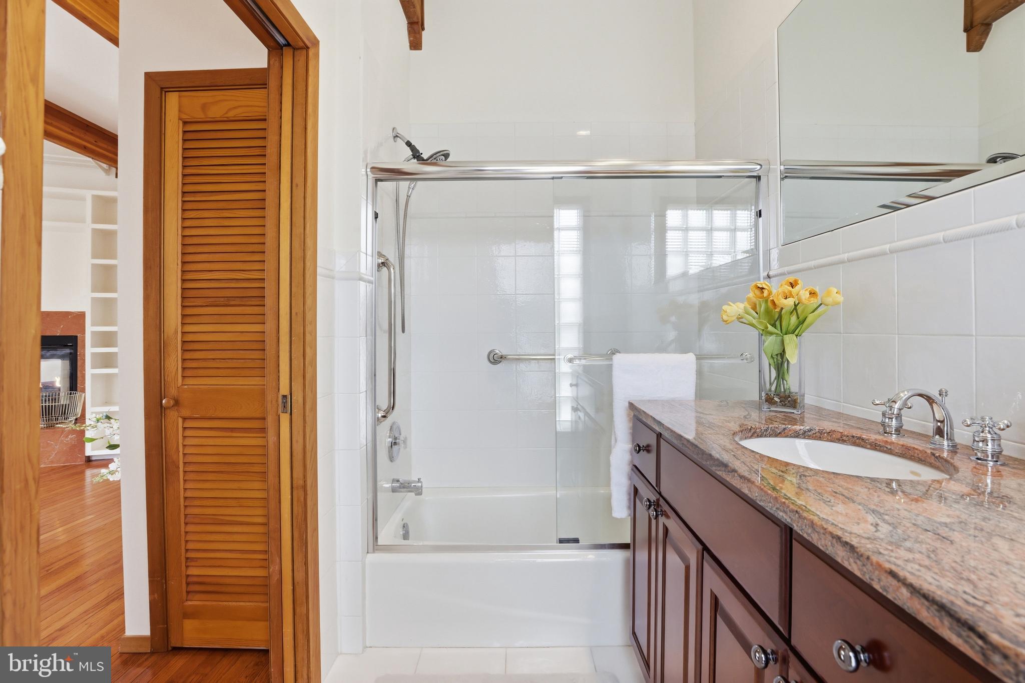 5931 Tyler Road Deale, MD 20751 - Photo 37 of 77 a bathroom with a granite countertop sink and a mirror